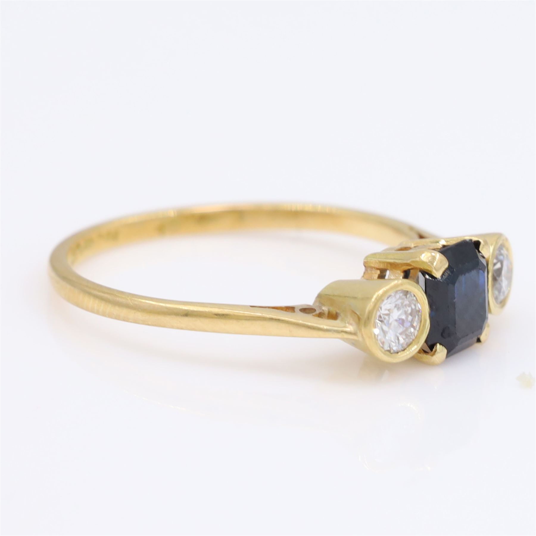 18ct gold sapphire and diamond three stone ring, single octagonal cut sapphire, with a single round brilliant cut diamond set either side, total diamond weight approx 0.25 carat