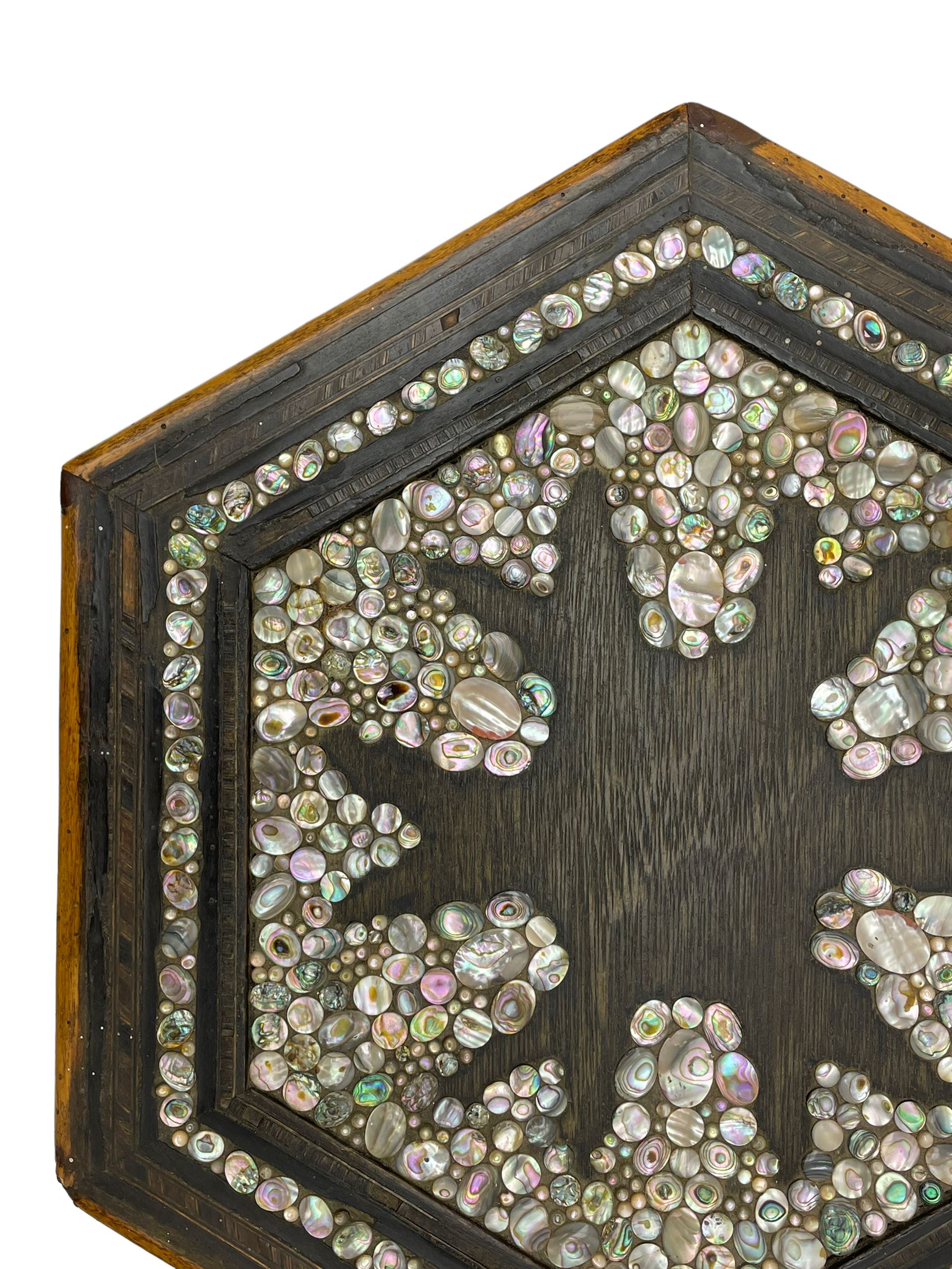 Early 20th century Anglo-Indian hexagonal table, the top decorated with mother of pearl beads and chequered banding, the base with fretwork pointed arches and inlays
