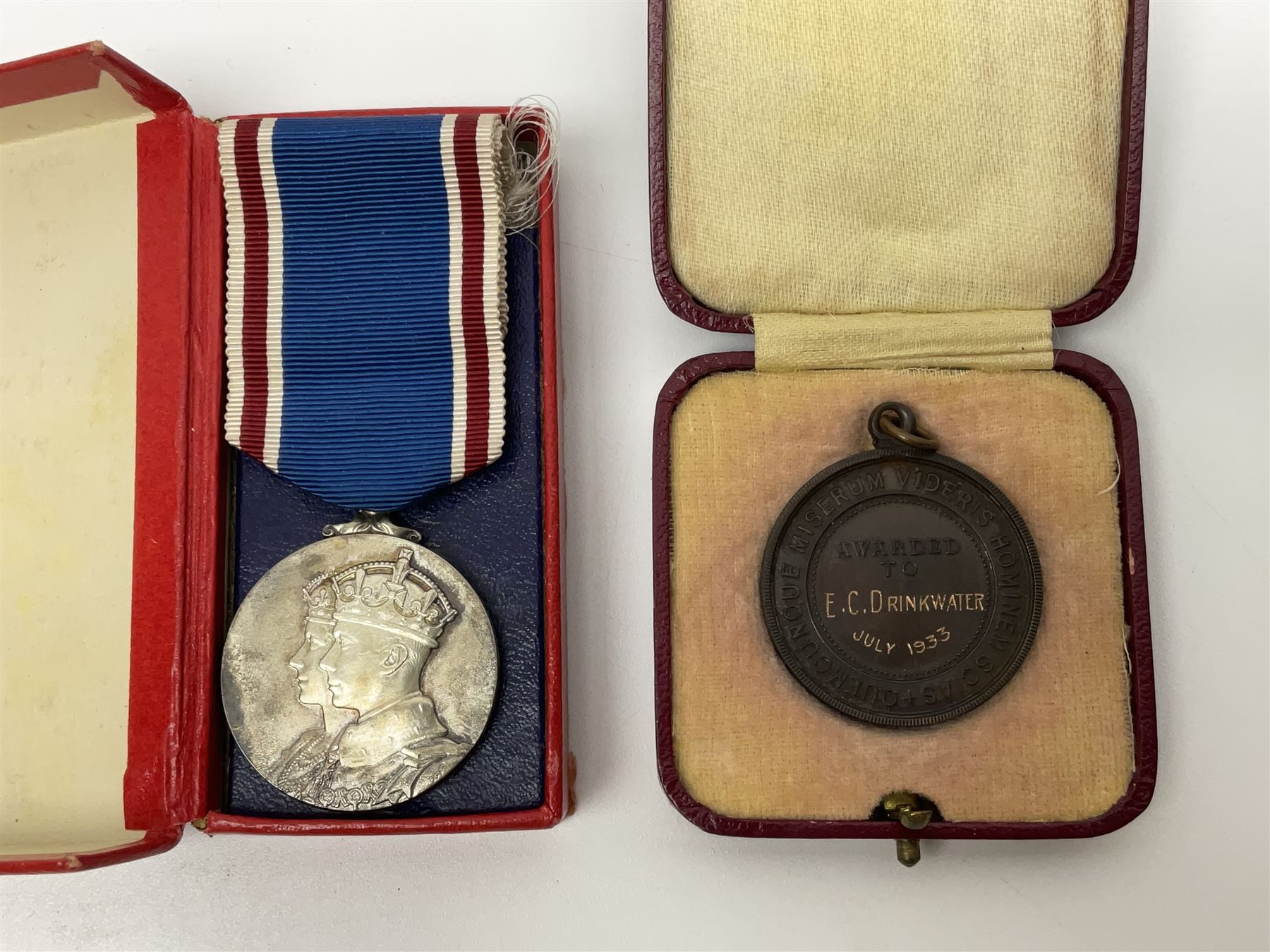 Collection of WW2 and police medals c.1933-1955, awarded to Eric Drinkwater comprising 1939-45 War Medal, Defence Medal, 1939-45 Star and Burma Star, on wearing bar; 1918-62 General Service Medal with Cyprus clasp to P.S. E.G. Drinkwater; boxed; Police Long Service and Good Conduct Medal to Const. Eric C. Drinkwater; cased; Royal Life Saving Society bronze medal to E.C. Drinkwater July 1933; boxed; and George V 1937 coronation medallion; boxed.