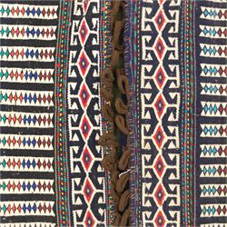 North East Persian Turkoman saddle bag, flatwoven wool with striped field of multicoloured diamond motifs, flanked by geometric borders in crimson and indigo, joined at centre with original braided fastening