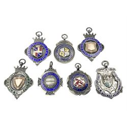 Seven early 20th century and later silver and enamel cartouche fobs, all relating to football, to include a circular example, with central rose gold cartouche surrounded by a green enamel border, hallmarked Birmingham 1927, and six others all hallmarked with various dates and makers
