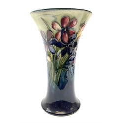 Moorcroft vase of trumpet form, decorated in the Spring flowers pattern upon a merging blue and green ground, with impressed and painted marks beneath, H20cm. 