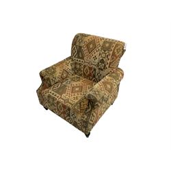 Traditional shaped armchair upholstered in patterned fabric