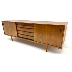 Heals teak sideboard, two sliding drawers enclosing adjustable shelves flanking five graduating drawers, turned tapering supports