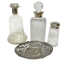 Two glass decanters with hallmarked silver collars, (and later stoppers), together with a glass sugar sifter and silver cover, hallmarked Birmingham, and a Continental silver plated pierced dish, (4)