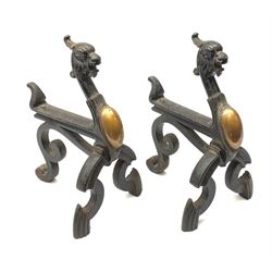 A pair of Victorian cast iron and copper fire dogs, with zoomorphic terminal, H32cm. 