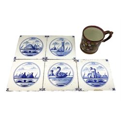 Five 19th century blue and white Delft tiles, each decorated with a central circular panel, containing buildings, boat, and swan, and a Victorian lustre mug decorated with polychrome flowers, tiles H13cm W13cm. 