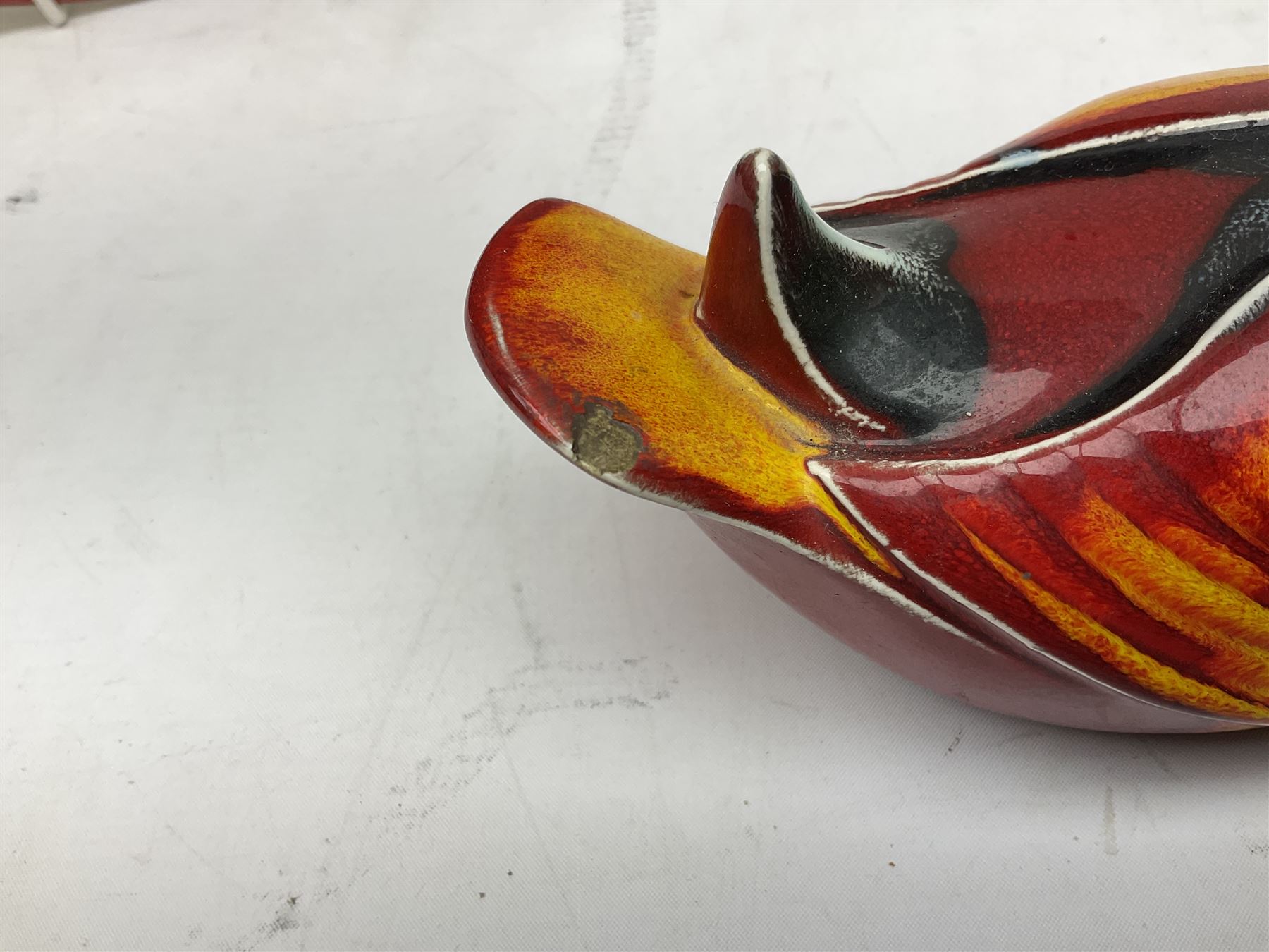 Collection of Poole Pottery, comprising charger and vase in Volcano pattern and a duck figure in a similar pattern 