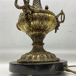 Cast brass table lamp, with lattice and foliate decoration and three loop handles, the marble base upon three bun feet, H71cm