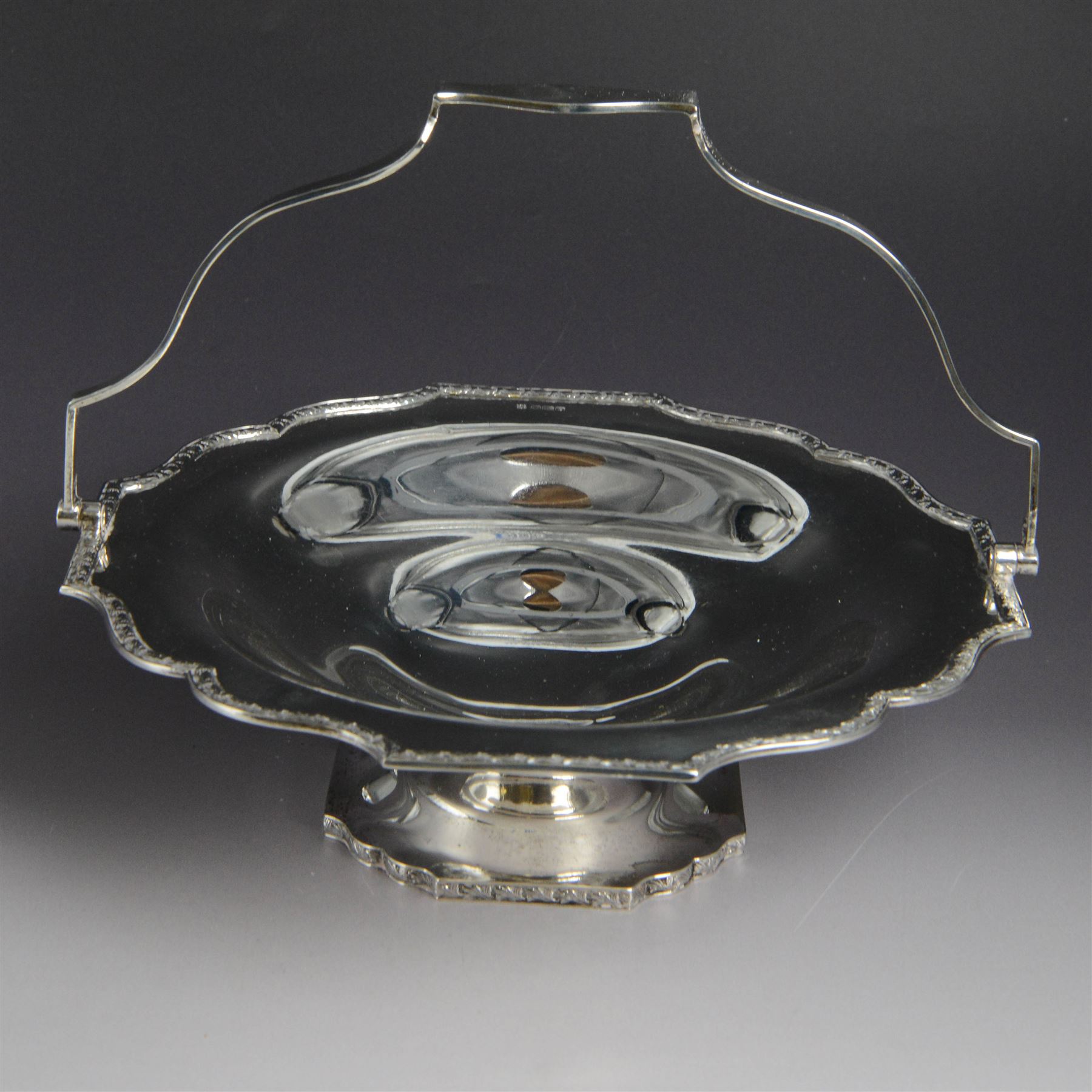 1920s silver swing handled pedestal dish, of octagonal form with shaped rim and foliate border, upon a similar pedestal, hallmarked Cooper Brothers & Sons Ltd, Sheffield 1922, not including handle H7cm