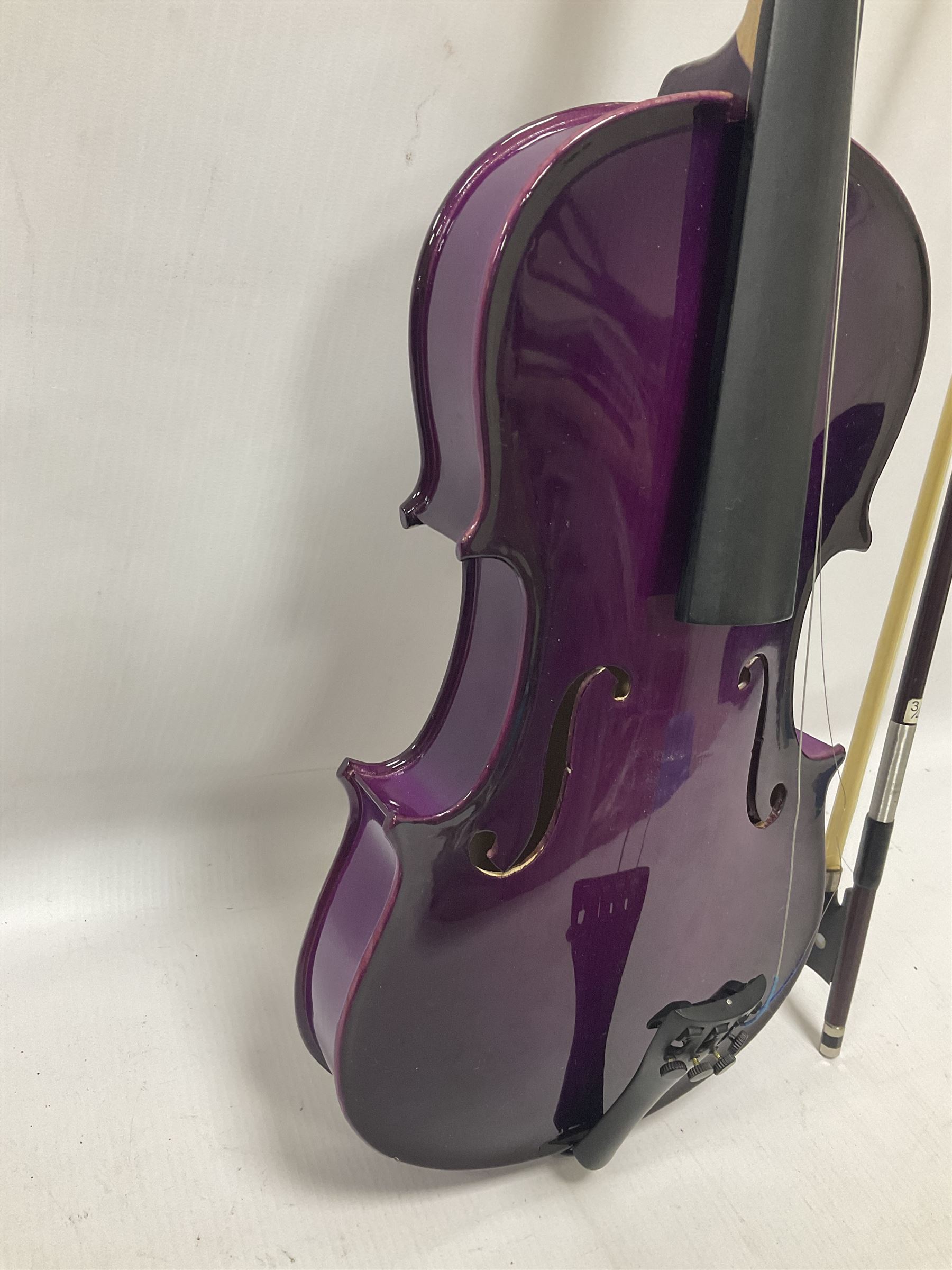 Intermusic 3/4 violin with a violet coloured solid wood body, ebonised fingerboard and fittings, bow and hard case, length 54cm