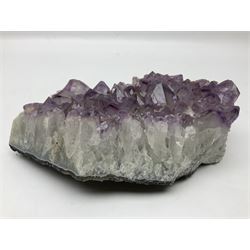 Amethyst crystal geode cluster, with well-defined crystals of various sizes, H10cm, L30cm
