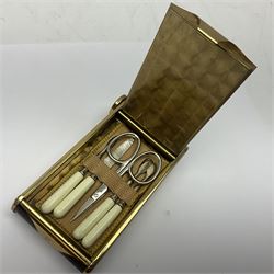 Art Deco musical powder compact, in the form of a camera, with simulated tortoiseshell and brass banded borders, containing manicure set, lipstick holder and powder compartment, with original felt outer case and box