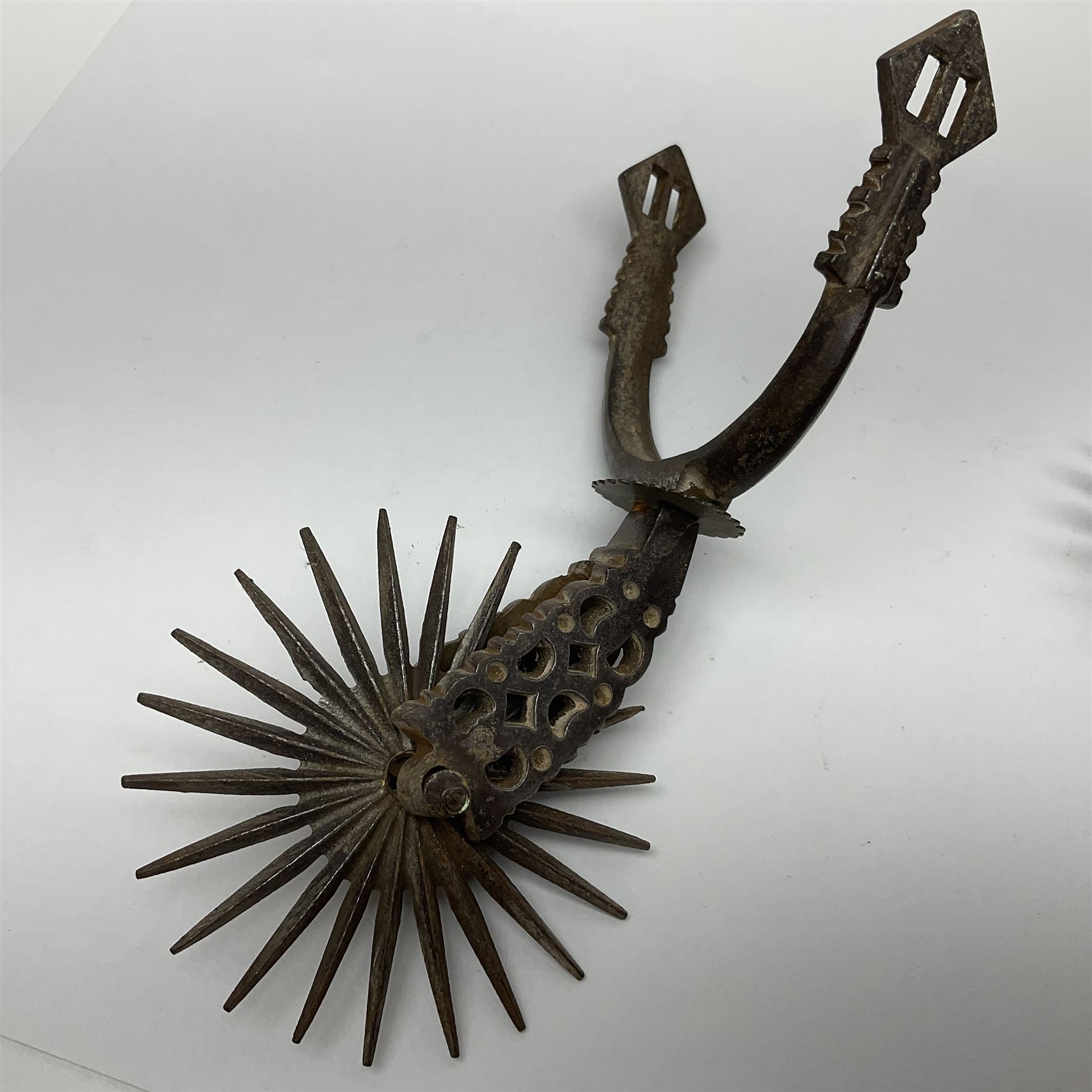 Pair of South American gaucho steel and brass spurs with twenty-two spike heel rowels, possibly Chilean L23cm