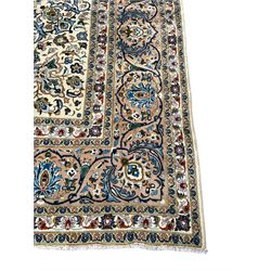 Persian Kashan ivory ground carpet, the interlaced foliate medallion surrounded by trailing plant motifs interlaced with scrolls, the guarded border with repeating stylised flower heads