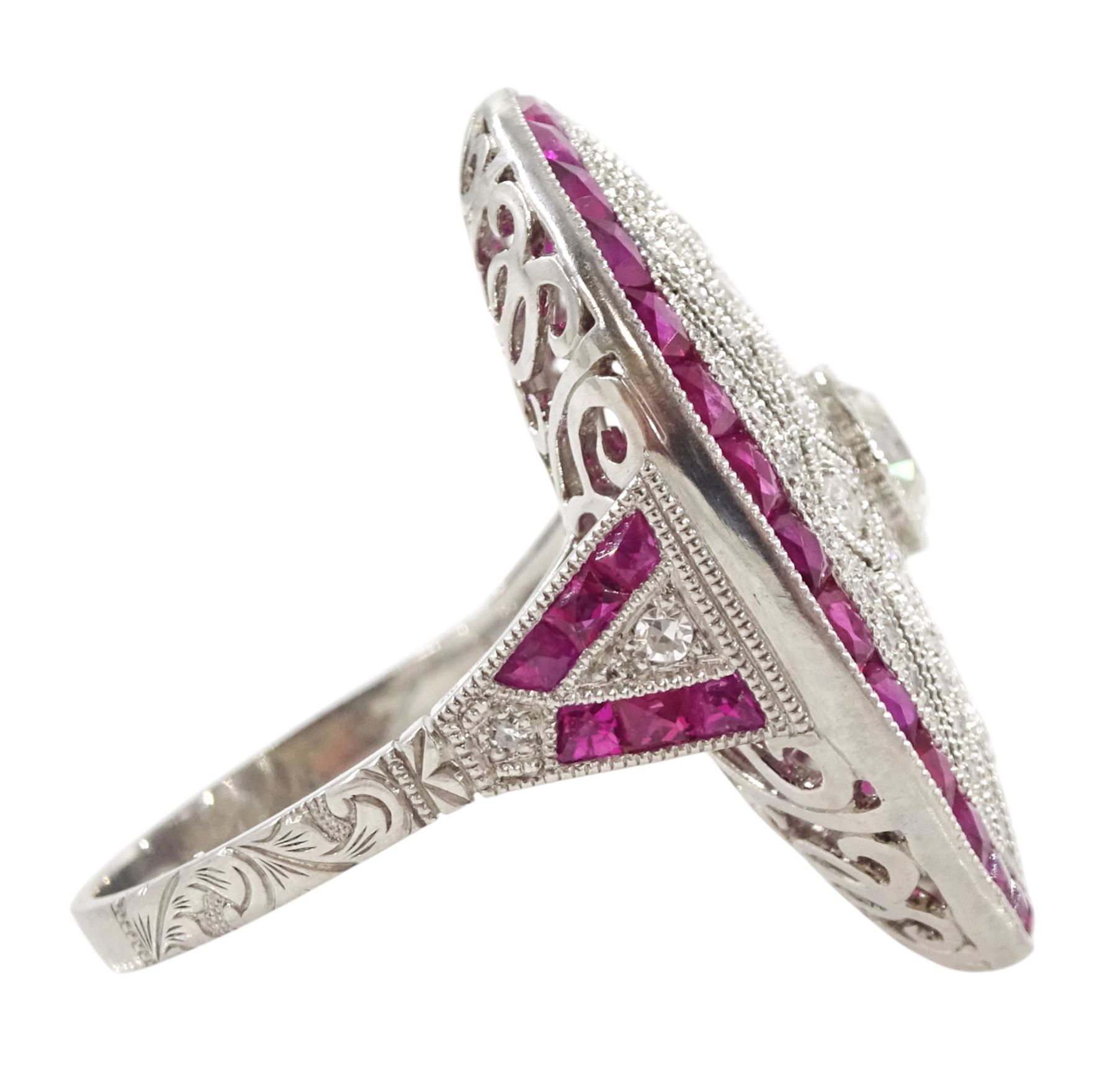 Platinum diamond and ruby oval cluster ring, principal transitional cut diamond of approx 0.55 carat, with milgrain set openwork diamond surround and calibre cut ruby border, with ruby and diamond shoulders