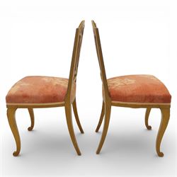 Edwardian pair of satinwood side chairs, each with shaped crest rail above an intertwining oval pierced splats centred by a floral patera, upholstered drop-in seats, raised on cabriole supports with applied floral mounts to the knees