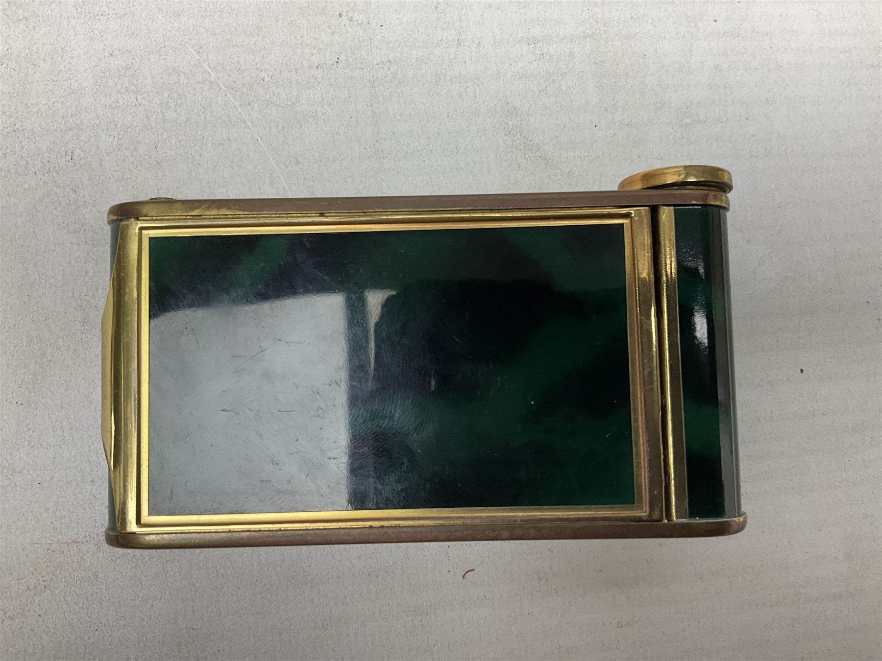 Art Deco camera shaped lady's musical compact and cigarette case, probably German, with green marble effect panels and gilt highlights, with large hinged opening to reveal engine turned brass interior with cigarette or lipstick holders, and the other side with musical mechanism and flip action powder compartment with mirror, L10cm