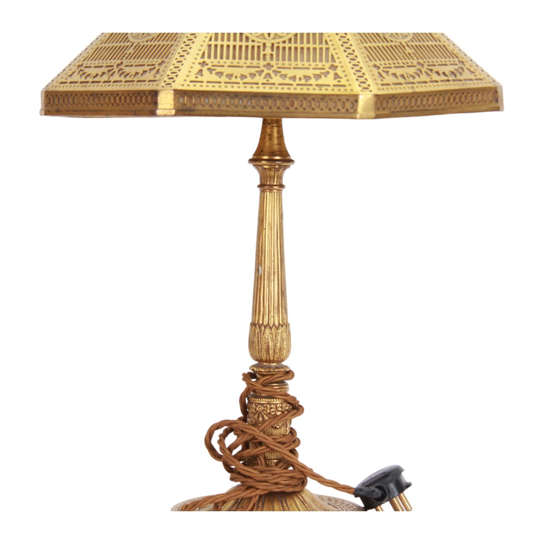 In the manner of Tiffany & Co, early 20th century gilt bronze Adam pattern table lamp, circa 1910, the circular spreading base decorated with flower heads and beaded bands, stiff leaves and husks, leading to a reeded column detailed with stiff leaves and swags, supporting a pierced octagonal shade, with original fittings, stamped beneath Tiffany Studios New York 539, overall H44.5cm


