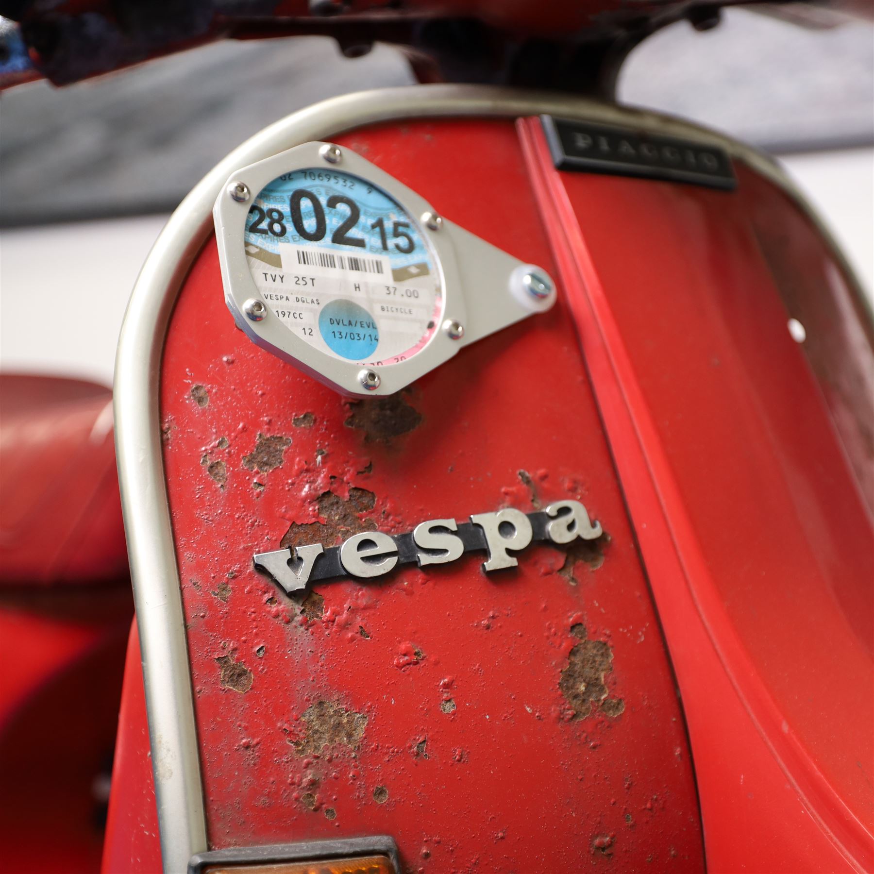 1979 Piaggio Vespa 200 Scooter

• Registration: TVY 25T
• Date of first registration: 1979
• Engine: 197cc petrol
• Odometer reading: 9,960 miles
• Colour: Red
• V5C: Present
• Keys: One

A 1979 Piaggio Vespa 200, registered TVY 25T and finished in red. Powered by a 197cc petrol engine, the scooter displays 9,960 miles on its Veglia Borletti odometer, although this mileage has not been independently verified.

The Vespa 200 is one of the larger-capacity models in the classic Vespa range, combining the marque’s distinctive pressed-steel construction with a practical 197cc engine and traditional handlebar gear change.

This example is presented in largely original and unrestored condition, retaining its period bodywork, Piaggio and Vespa badging, original-style controls and Yankee-branded dual seat.

The scooter shows extensive age-related wear throughout, including paint loss, scratches, surface corrosion and deterioration to the bodywork, including a perforation to the inner legshield.

This vehicle forms part of the Estate of the Late John Sills and is offered for sale by the Executors, confirming a genuine reason for sale.