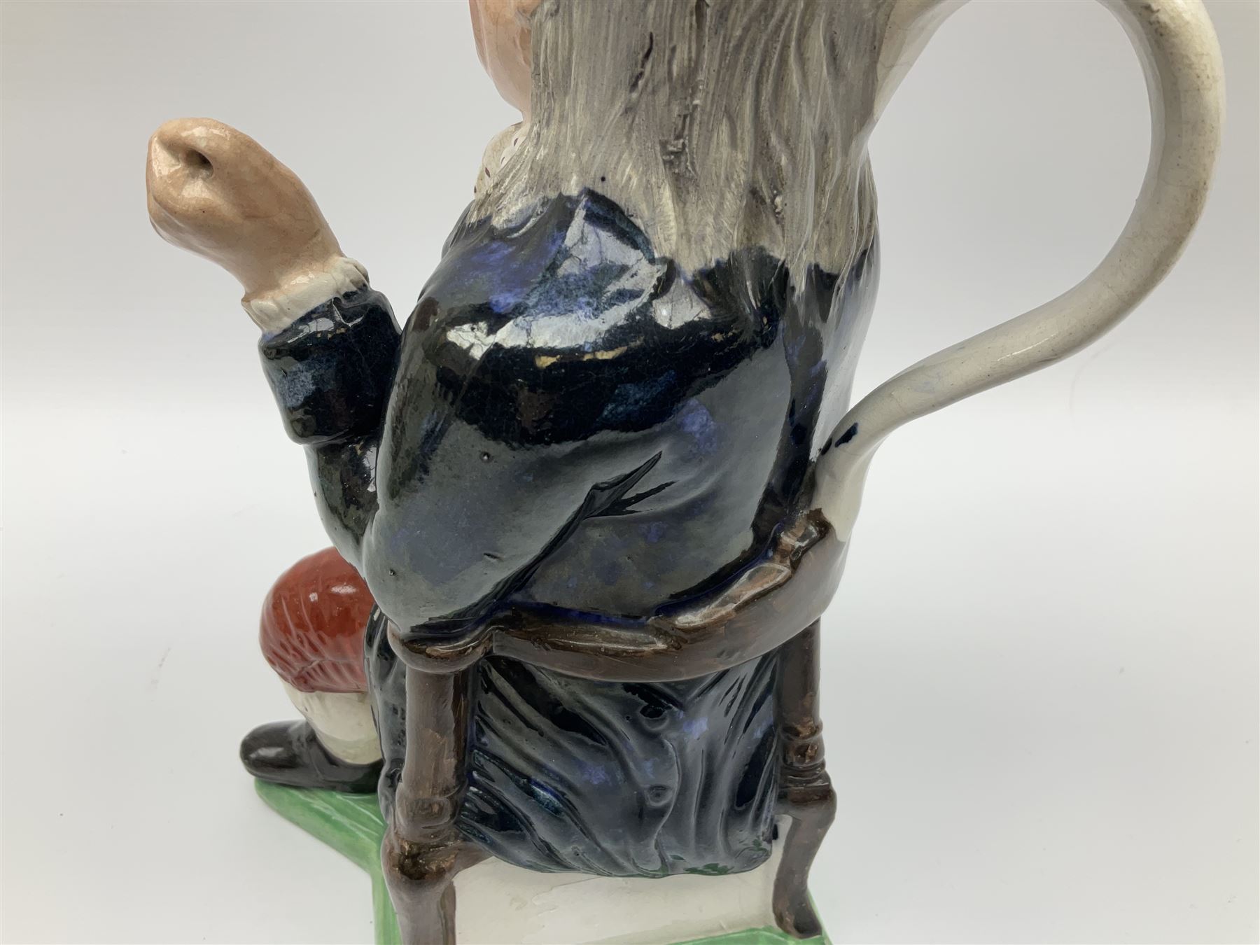 Early 20th century Staffordshire William Kent Squire toby jug, modelled seated upon a corner chair holding a jug of ale in his right hand, H28cm