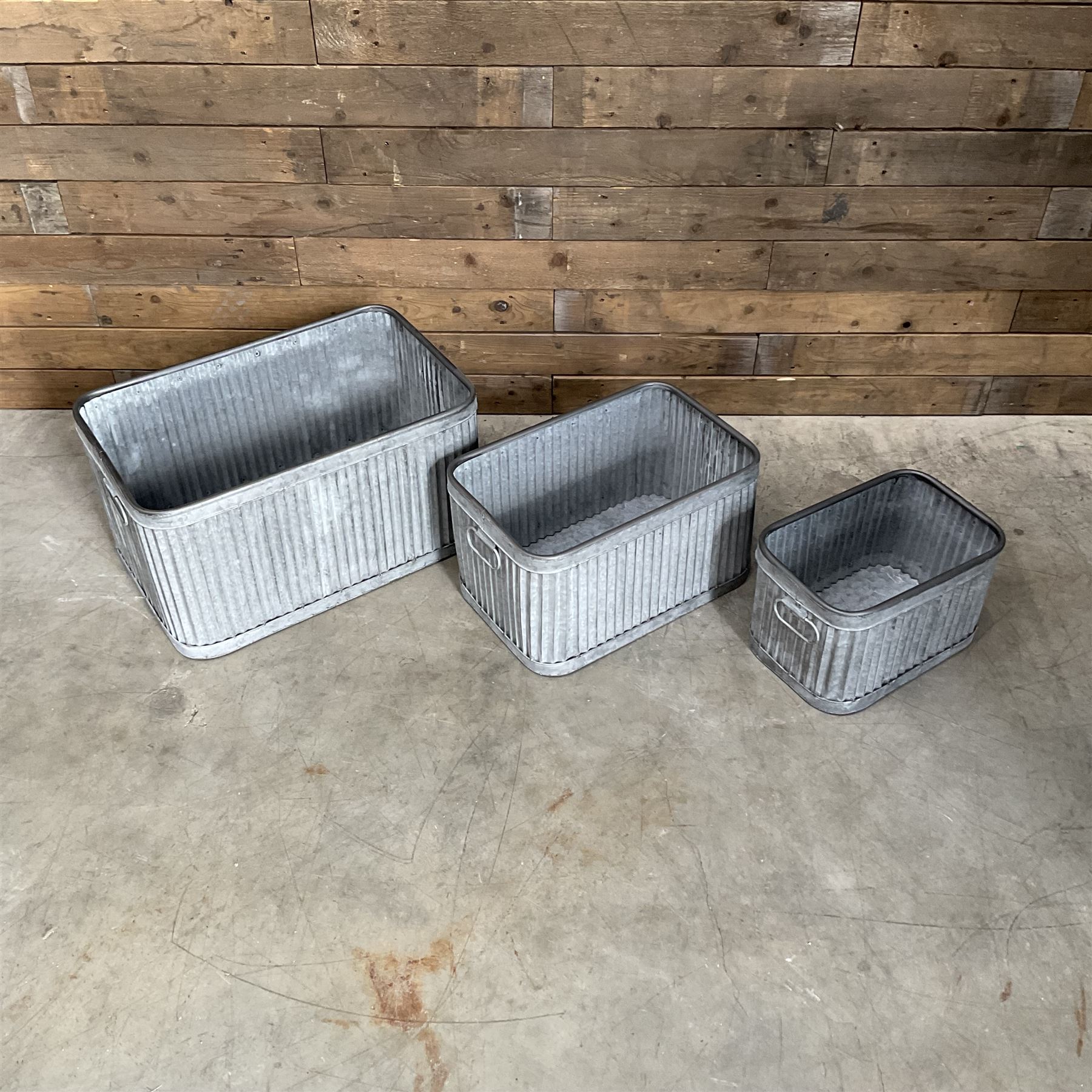Set of three pressed metal planters in different sizes