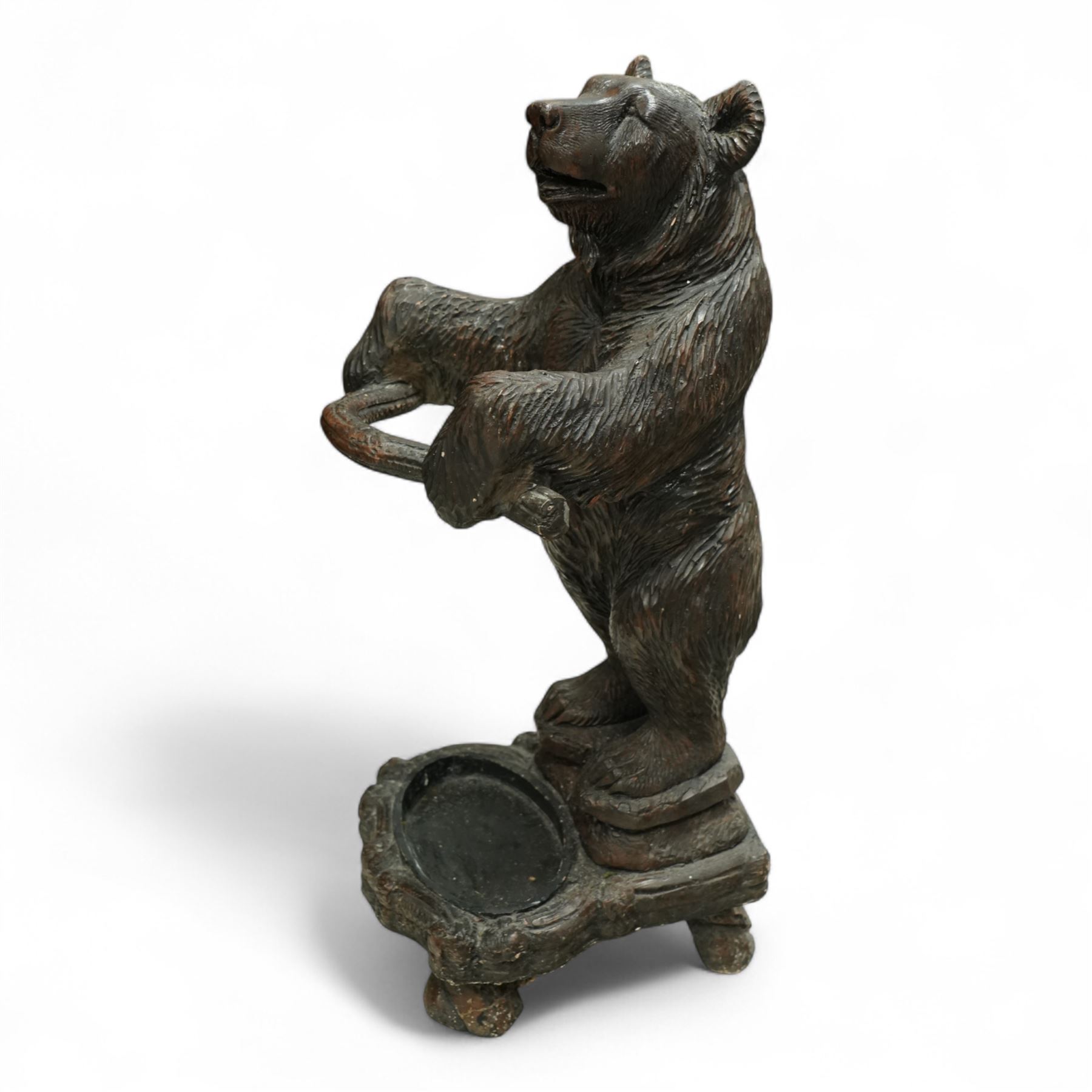 Early 20th century Black forest bear design stick stand, composite wood model of a bear with arms outstretched holding a branch forming the stick stand above a drip tray on tree branch form feet 