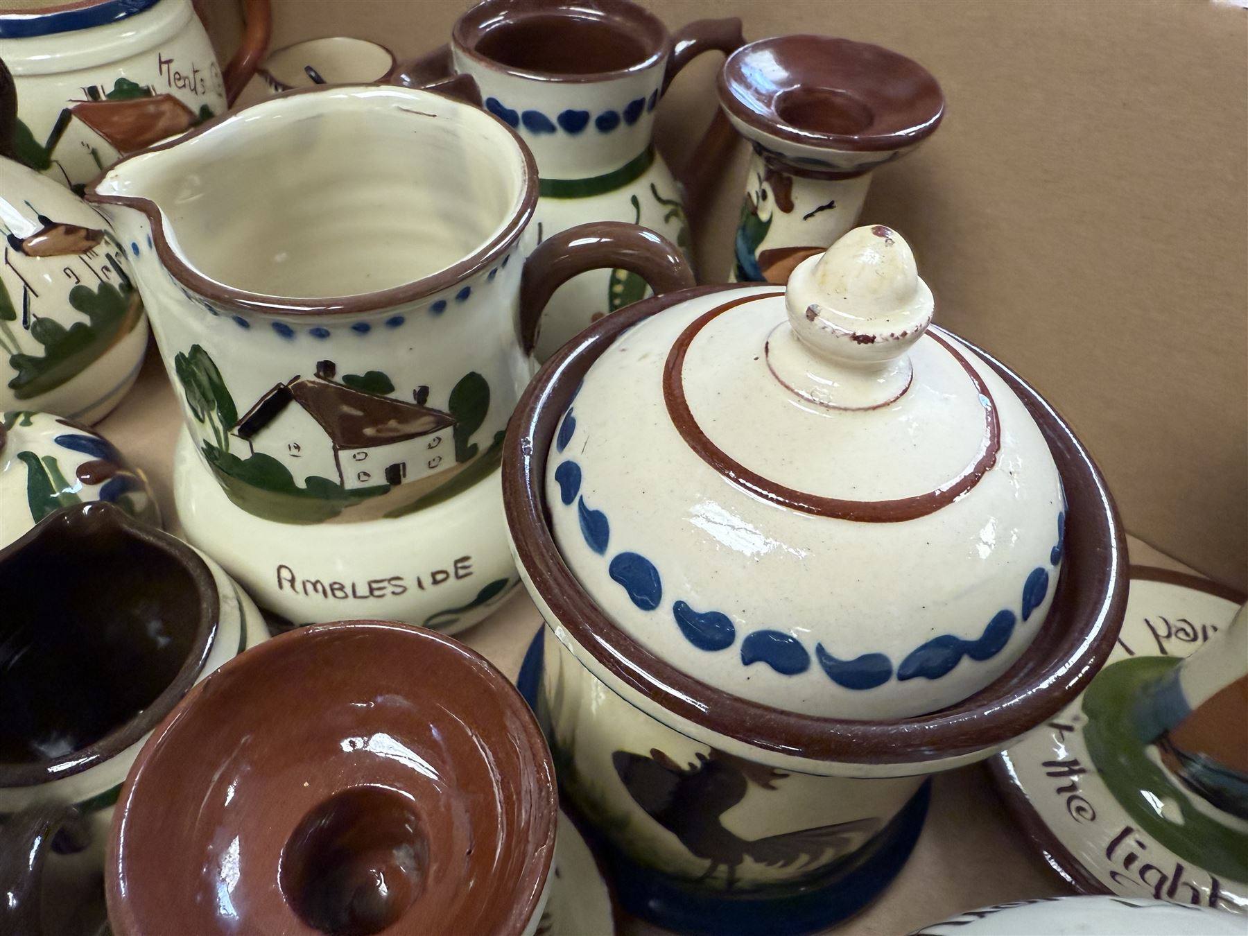 Collection of Torquay and similar Motto ware, including jugs, candlesticks, twin handled mug etc 