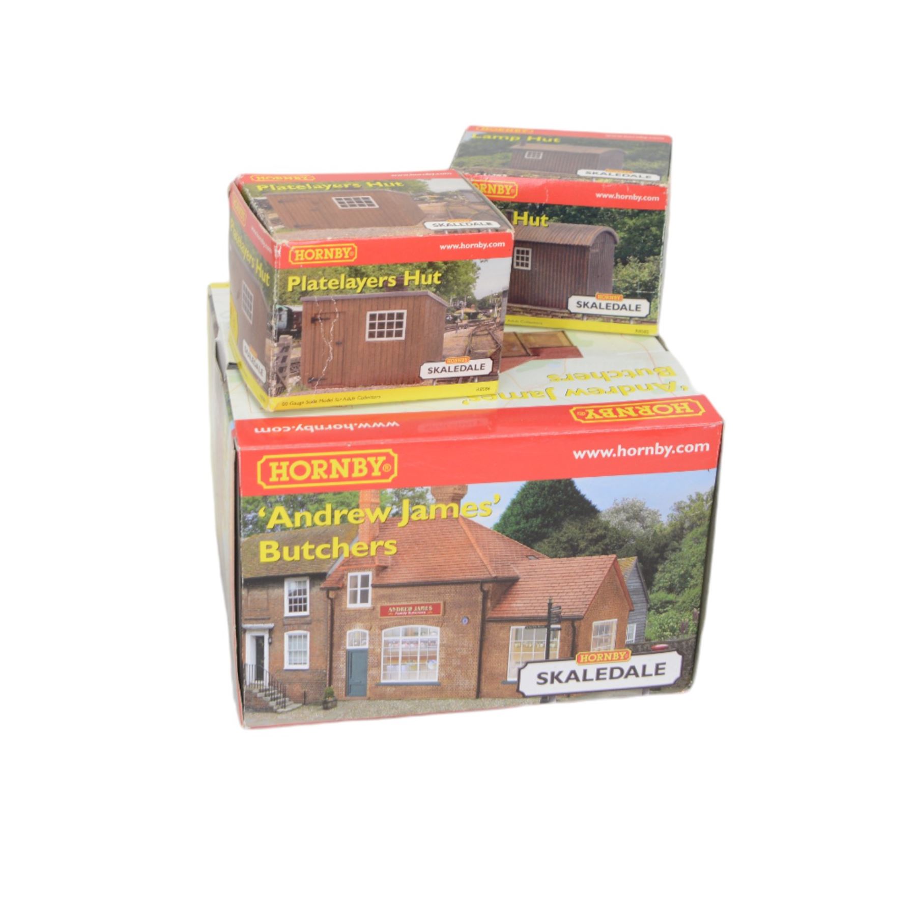 Eleven Hornby '00' gauge Skaledale buildings, comprising R9771 Three Barrels Wine Bar, R8534 Signal Box, R8747 Electricity Sub Station, R8585 Lamp Hut, R8586 Platelayers Hut, R8575 War Memorial, R9828 Bakers Shop, R9767 Andrew James Butchers, R8504 Holly Farm Cottages, R8566 The Boar's Head and R8513 The Vicarige, all boxed