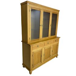 Light oak dresser, three glazed doors enclosing six adjustable glass shelves, with internal light fittings to top, above three drawers and three cupboards