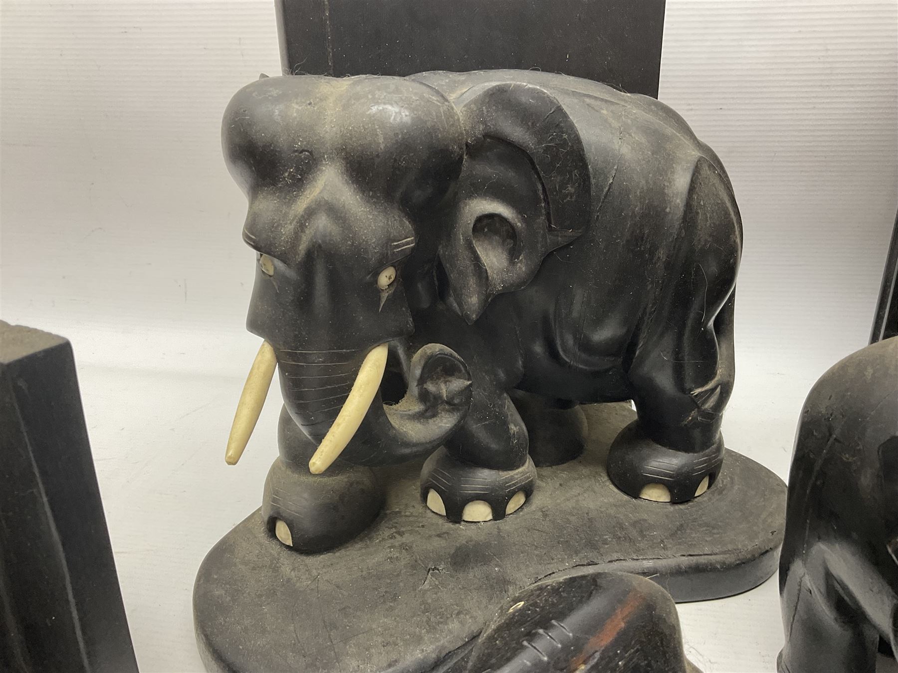 Three pairs of carved wooden elephant bookends, and a similar carved wooden elephant figure, tallest H24cm