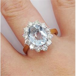 18ct gold oval aquamarine and round brilliant cut diamond cluster ring, hallmarked, aquamarine approx 2.10 carat, total diamond weight approx 0.75 carat