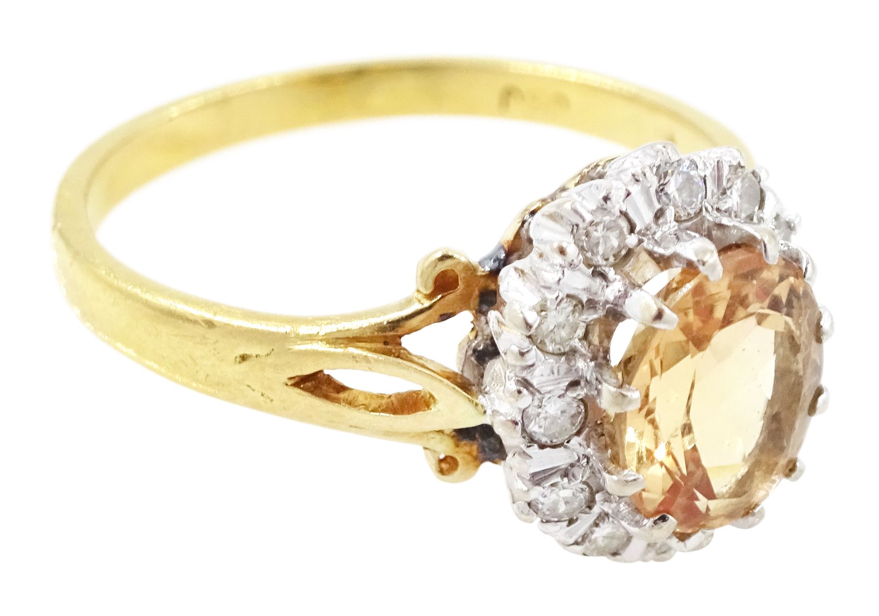 18ct gold imperial topaz and diamond cluster ring, oval cut topaz of approx 1.50 carat, surrounded by twelve round brilliant cut diamonds, London 1987, total diamond weight approx 0.10 carat