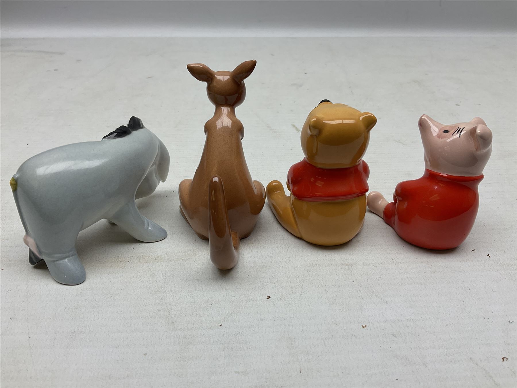 Set of eight Winnie the Pooh Beswick figures, comprising Christopher Robin, Winnie the Pooh, Tigger, Piglet, Rabbit, Eeyore, Owl and Kanger, six with original boxes, tallest H12cm  