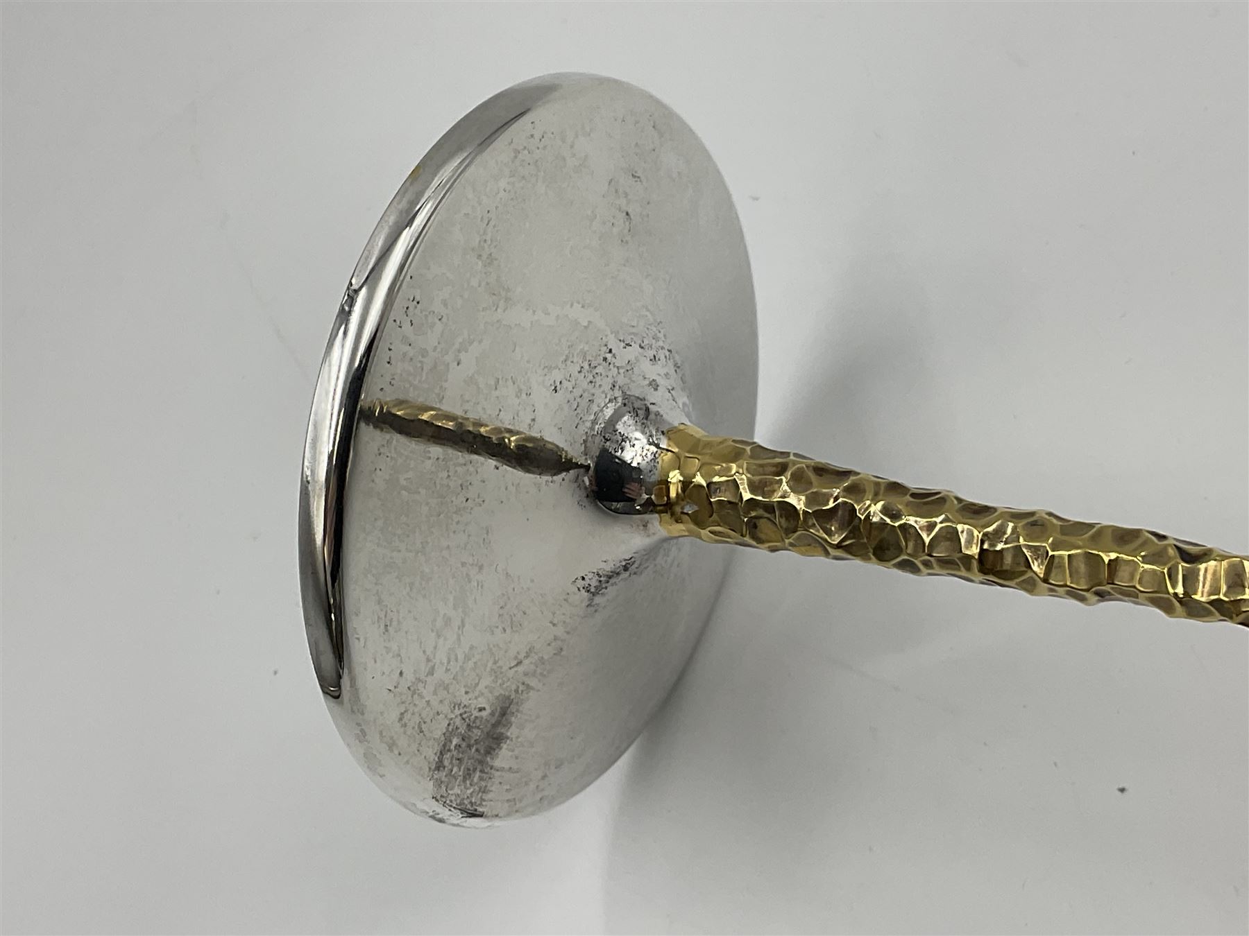 Pair of modern silver candlesticks by Stuart Devlin, the tapering parcel gilt stems with signature textured detailing, each supporting a fluted candle holder and upon a spreading circular foot, hallmarked Stuart Devlin, London 1973, H25cm