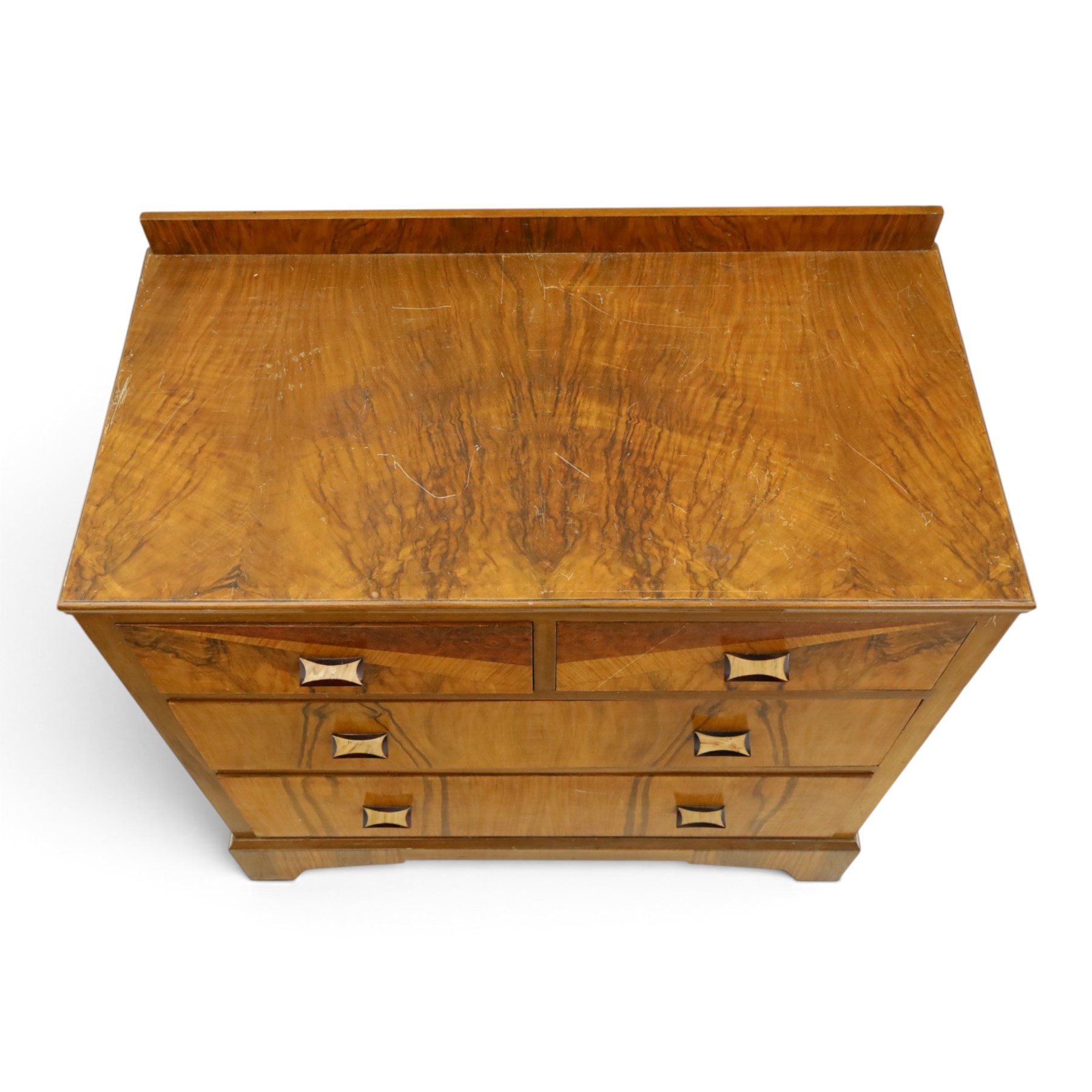 Art Deco figured and burr walnut chest, raised back over rectangular top, fitted with two short over two long drawers with decorative veneer and handles, on shaped bracket feet