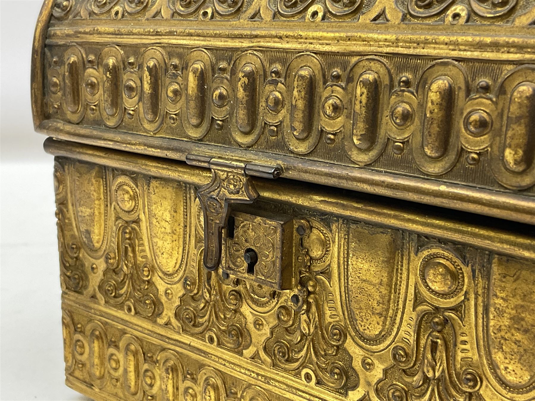 19th century brass repoussé perfume box, the ornately decorated casket with hinged domed cover lifting to reveal gold velvet lined interior containing three glass scent bottles, H14cm W15cm D7cm