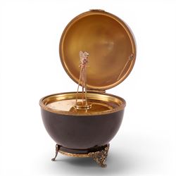Limoges Fabergé  'Movie Camera' egg, the black and gilt hinged lid opening to reveal a gilt interior with a film camera to the center, with certificate and box, H14cm