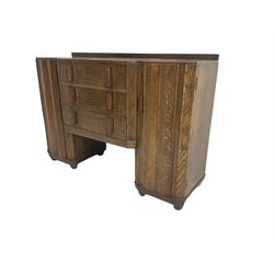 Early to mid-20th century Art Deco style oak sideboard, breakfront and fitted with three drawers and two cupboards, the cupboards enclosed by faceted door fronts