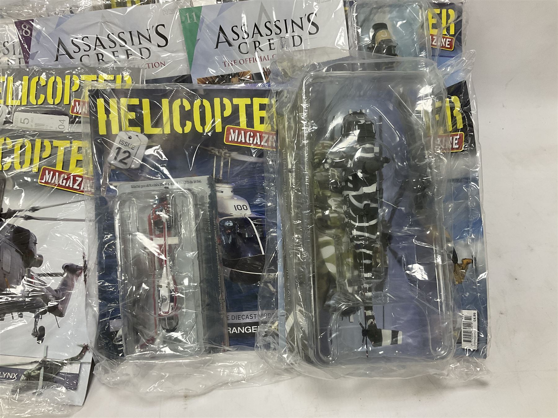 Fifteen Amer Czechoslovakia periodical issued metal models of helicopters each in unopened original packaging with copy of 'Helicopter Magazine'; together with seven unopened Hachette 'Assassin's Creed' periodical figures with magazines (22)