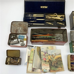 A selection of various writing accessories, to include a cased drawing instruments set, containging various dividers, compasses, and a folding rule, the case makred Cary Porter Ltd 7 Pall Mall London, a quantity of pen nibs, assorted inkwells, rubbers, and pens, etc., together with a selection of approximately forty postcards, to include a silk example. 