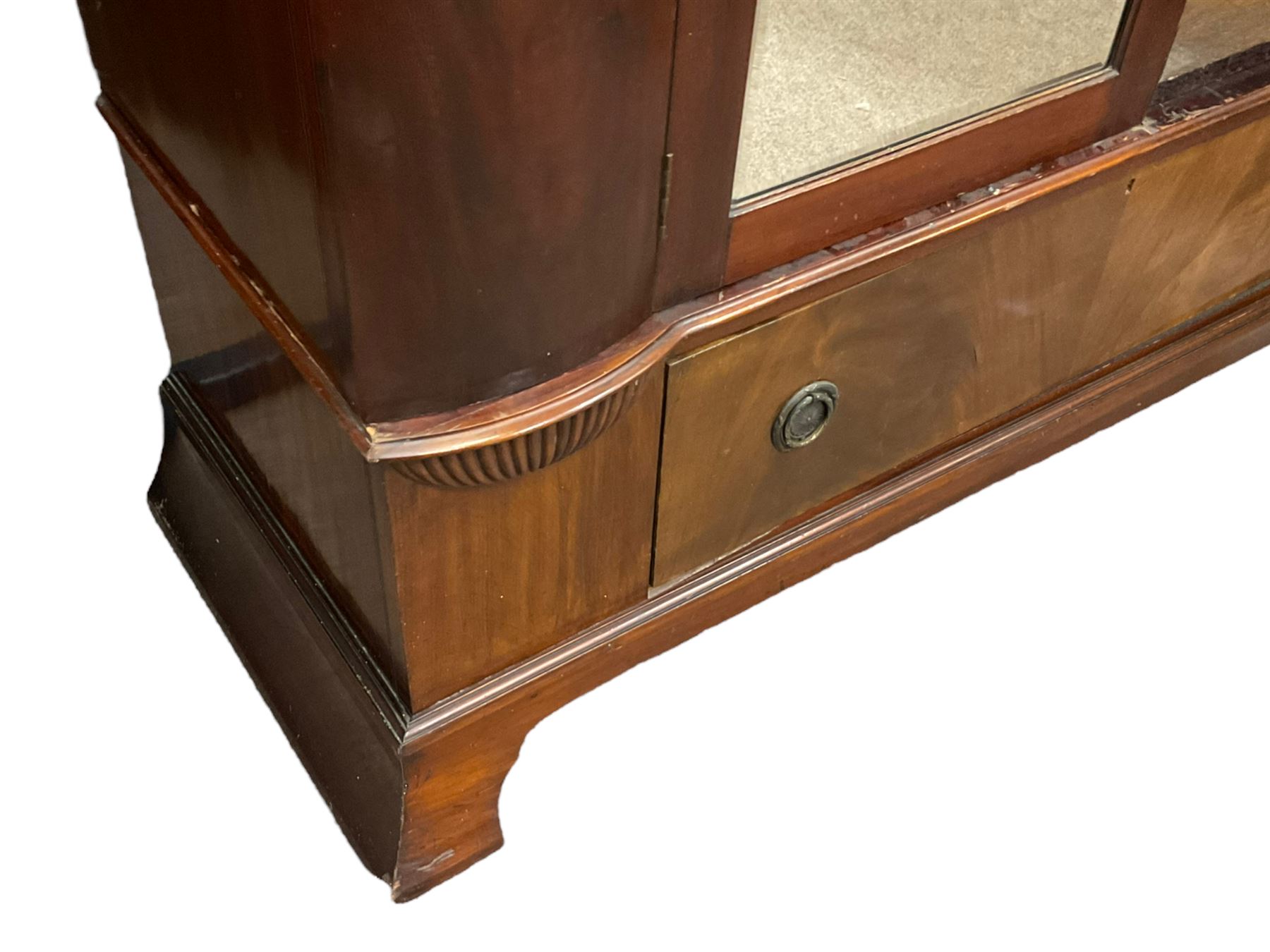 Late 19th century mahogany double wardrobe, projecting cornice over figured frieze, curved uprights enclosing two doors with bevelled mirrors, drawer to base, on splayed bracket feet