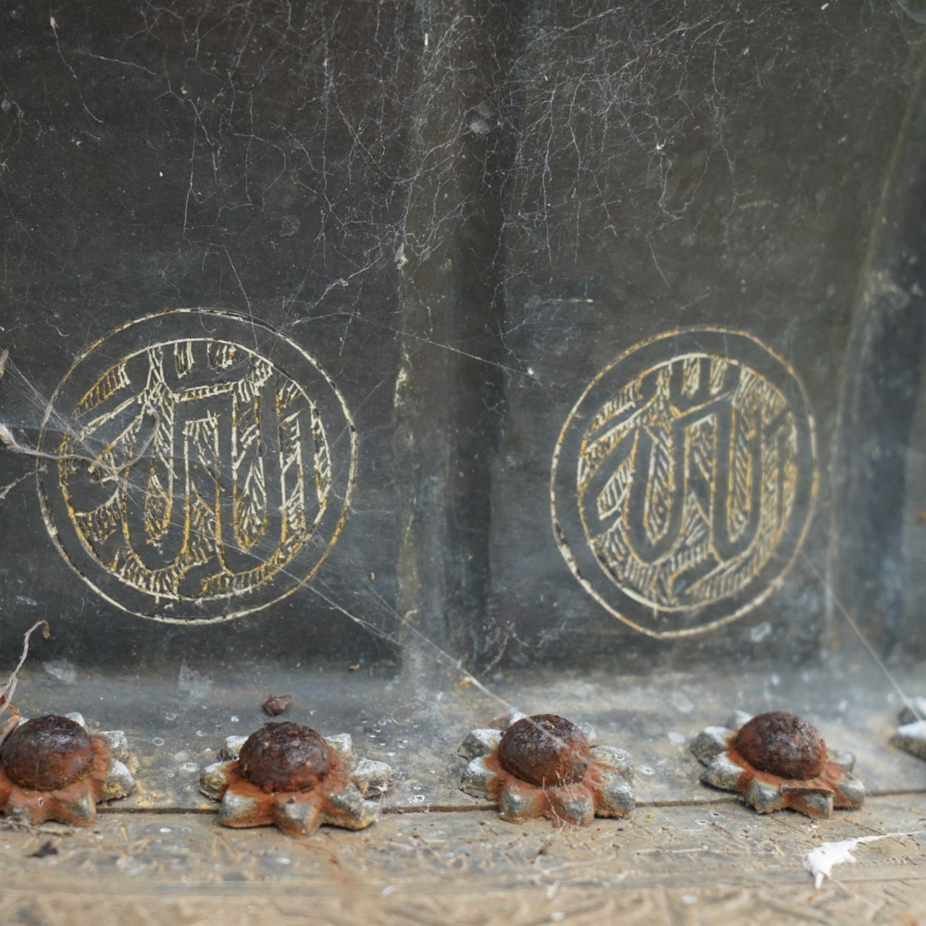 Pair of large Indian cast metal garden urns, each of bulbous form with engraved foliate and script panels, twin ring handles to the neck, raised on fluted pedestal bases