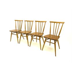 Four Ercol stick back chairs, turned supports joined by stretcher 