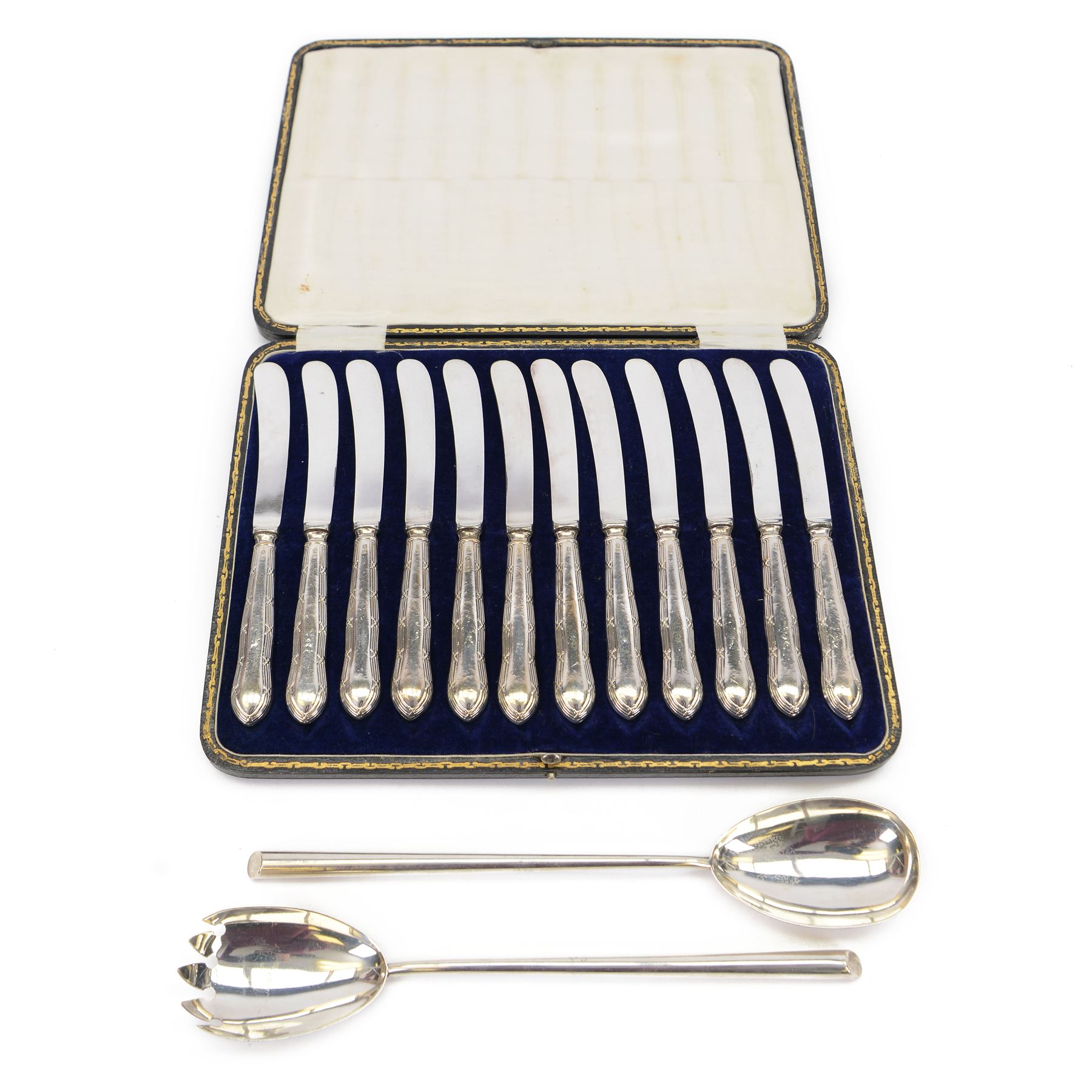 Pair of early 20th century silver salad servers, hallmarked John Grinsell & Sons, Birmingham 1919 or 1938, together with a set of twelve early 20th century silver handled butter knives, hallmarked Yates Brothers, Sheffield 1918, contained within a fitted case