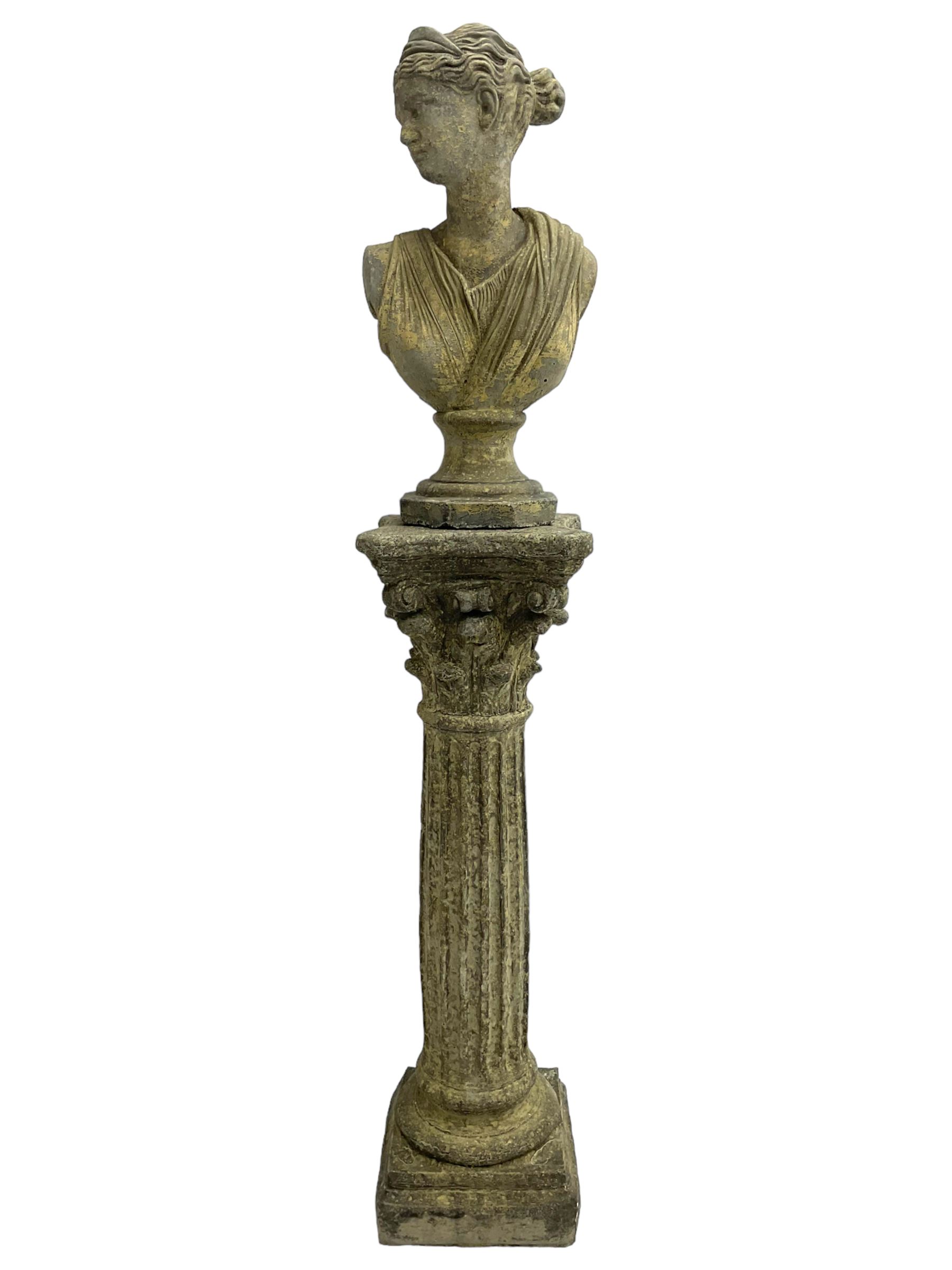 Classical design cast stone female bust depicting Artemis, raised on fluted Corinthian column with acanthus leaf capital, stepped square base, looking right 