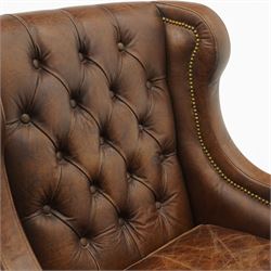 Timothy Oulton - pair of wingback armchairs upholstered in back-buttoned chocolate brown leather with loose seat cushion, raised on square tapering feet