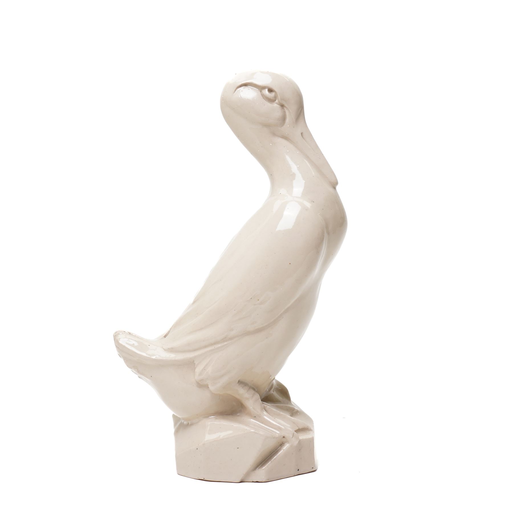 Early 20th century glazed figure of a duck perched upon a rock, signed 'E Grater' and dated 1935, H30cm 