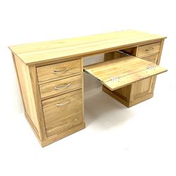 Light oak twin pedestal computer desk, one central long drawer flanked by two short drawers, above graduating drawers and cupboard