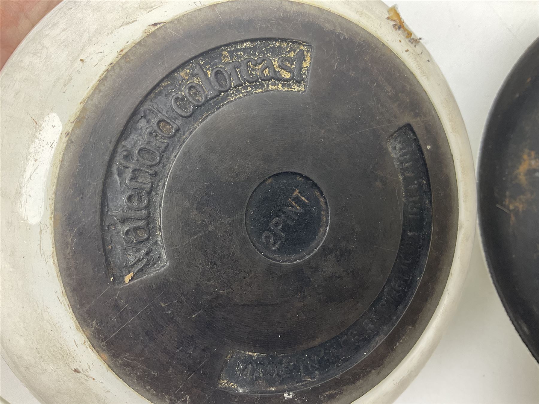 Le Creuset cast iron casserole dish, together with two Waterford cast iron dishes and a frying pan